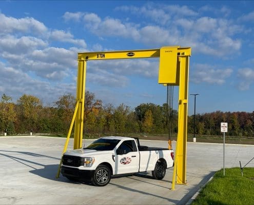 Outdoor monorail solution by CraneWerks for a national commercial truck dealer to undeck tractors in Detroit, Michigan